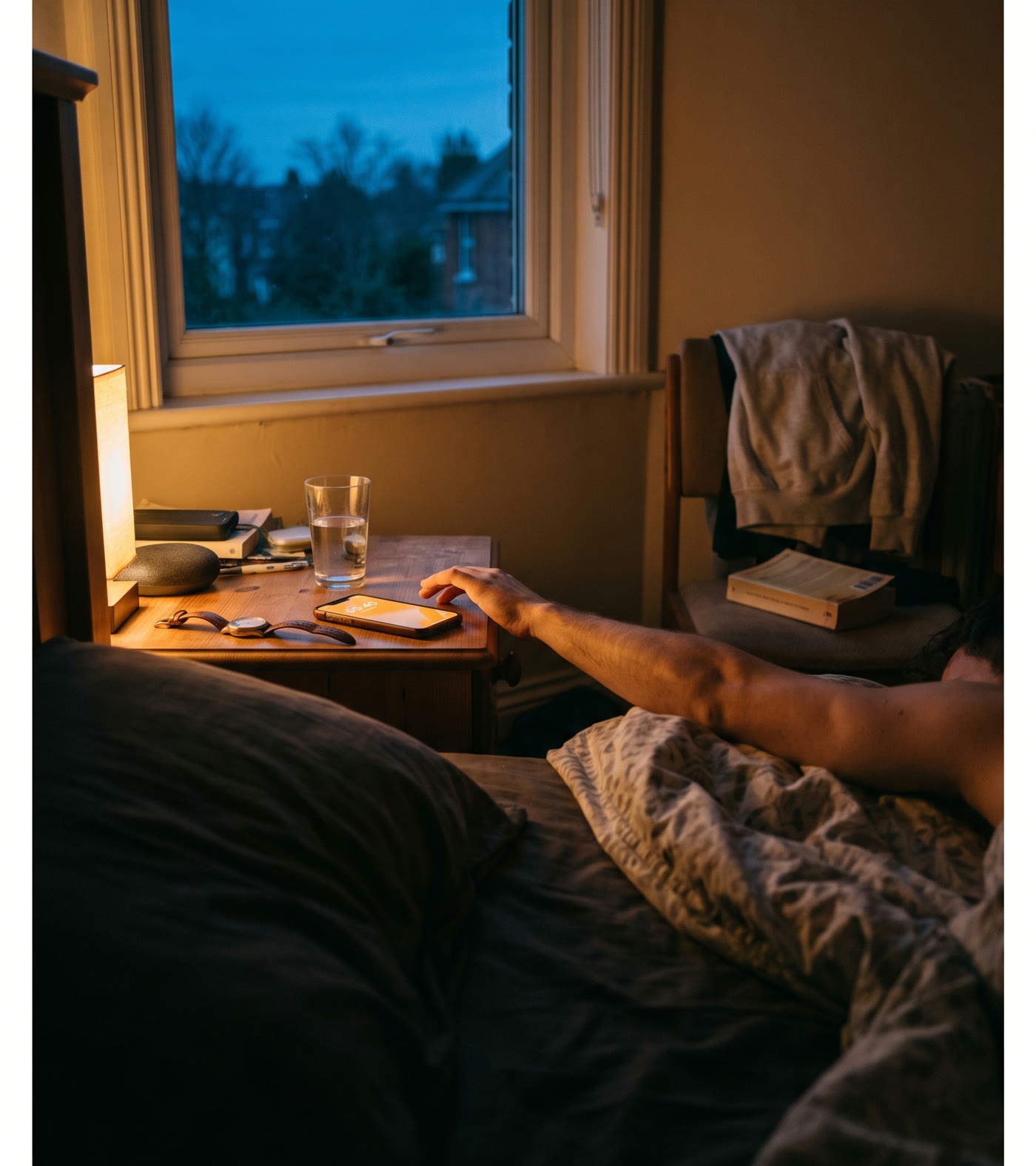 A dark bedroom at 5:40 am, a hand reaching for a glowing phone alarm